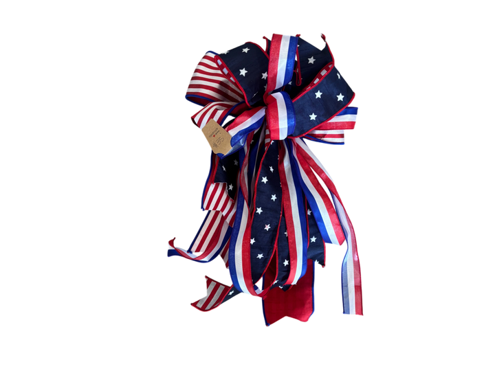 Chic Collective patriotic ribbon bow with red, white, and blue star and stripe patterns for holiday decor.