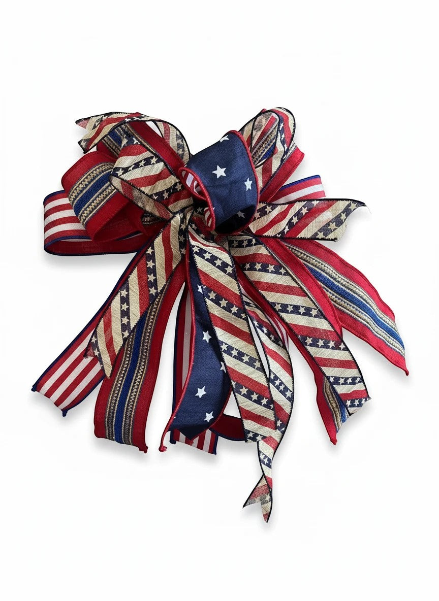 Chic Collective patriotic ribbon bow featuring red, white, and blue stars and stripes patterns for seasonal decor.
