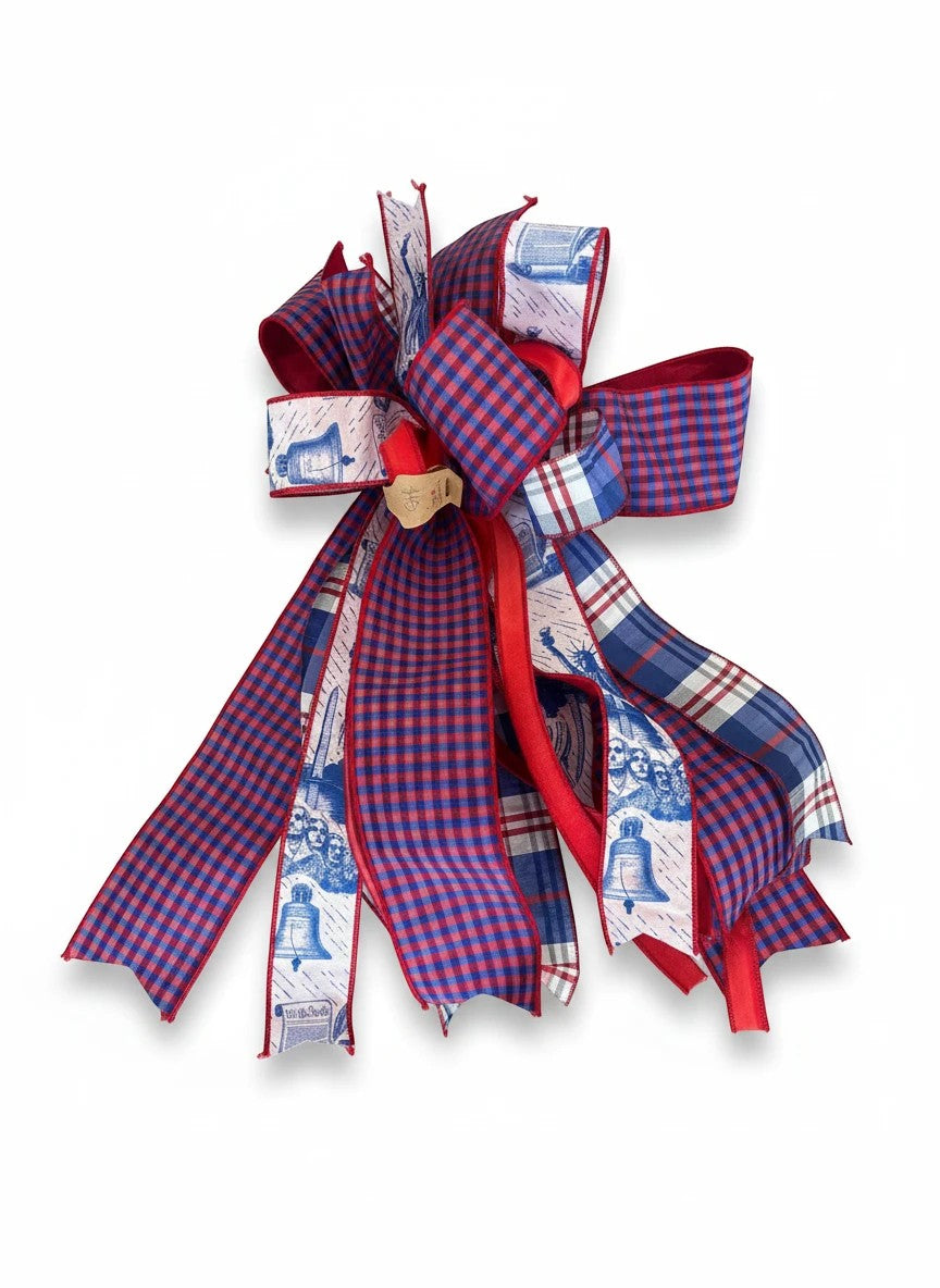 Chic Collective patriotic ribbon bow with red, white, and blue plaid and Liberty Bell patterns for holiday decor.