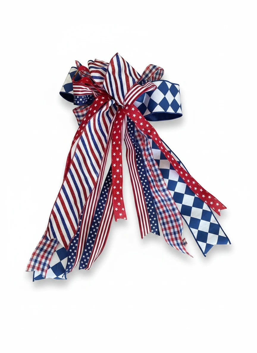 Chic Collective patriotic ribbon bow with red, white, and blue stripes, stars, gingham, and diamond patterns.