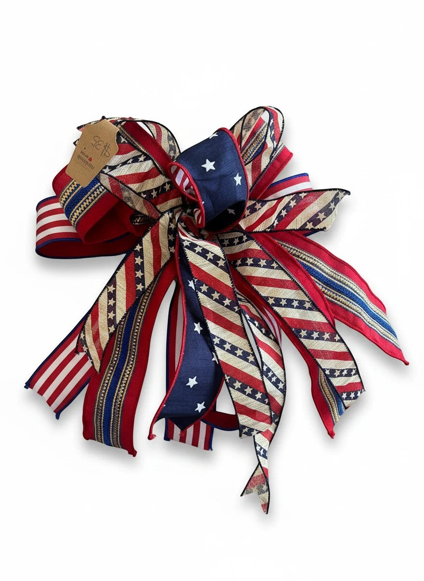 Chic Collective patriotic ribbon bow with red, white, and blue stars and stripes patterns for seasonal home decor.