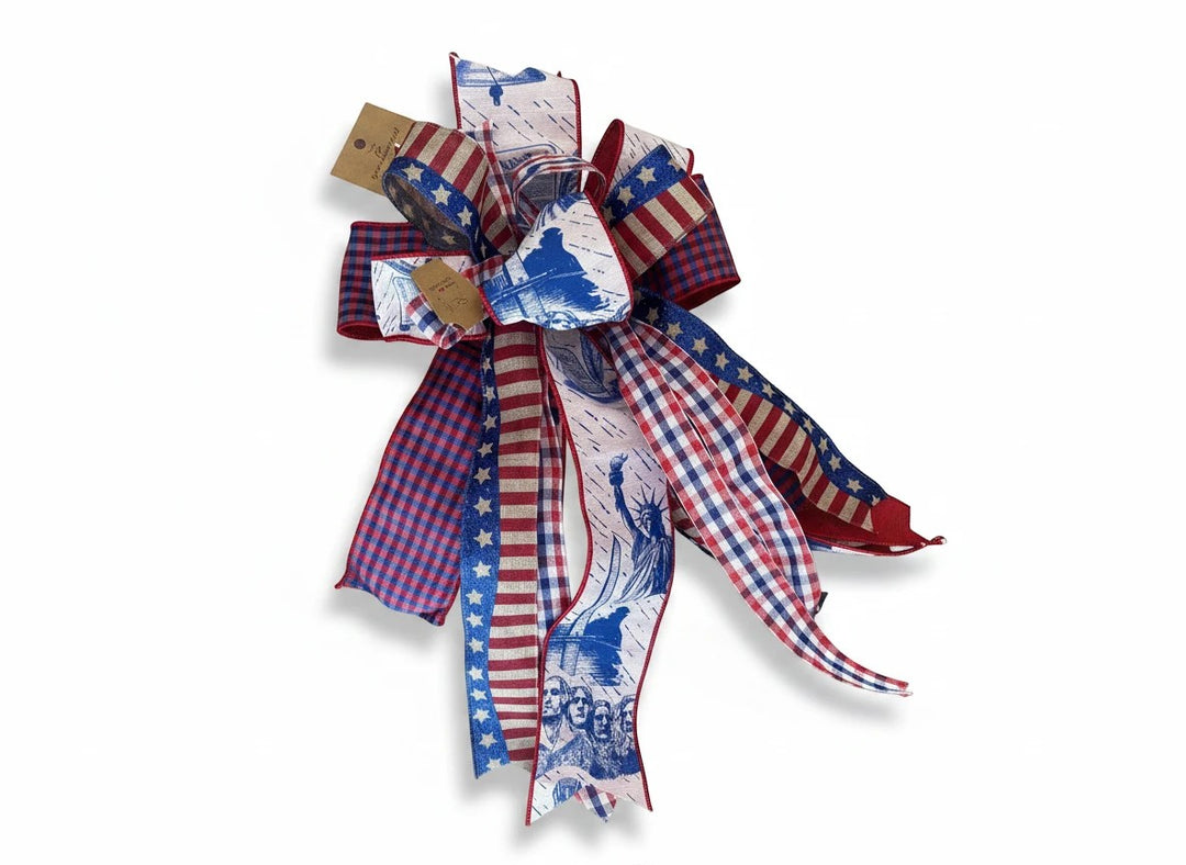 Chic Collective patriotic ribbon bow with red, white, and blue stars, stripes, and iconic American landmark prints.