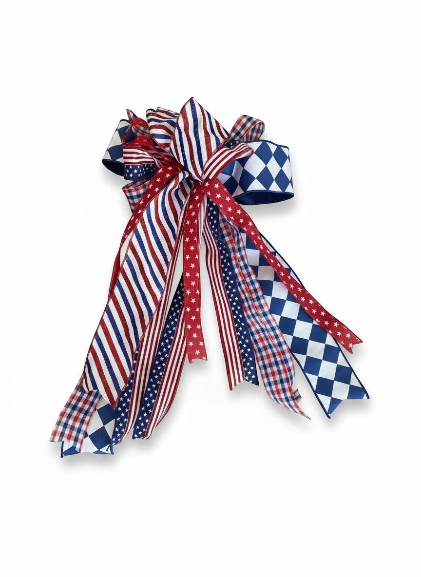 Chic Collective patriotic ribbon bow with red, white, and blue stripes, stars, gingham, and diamond patterns.