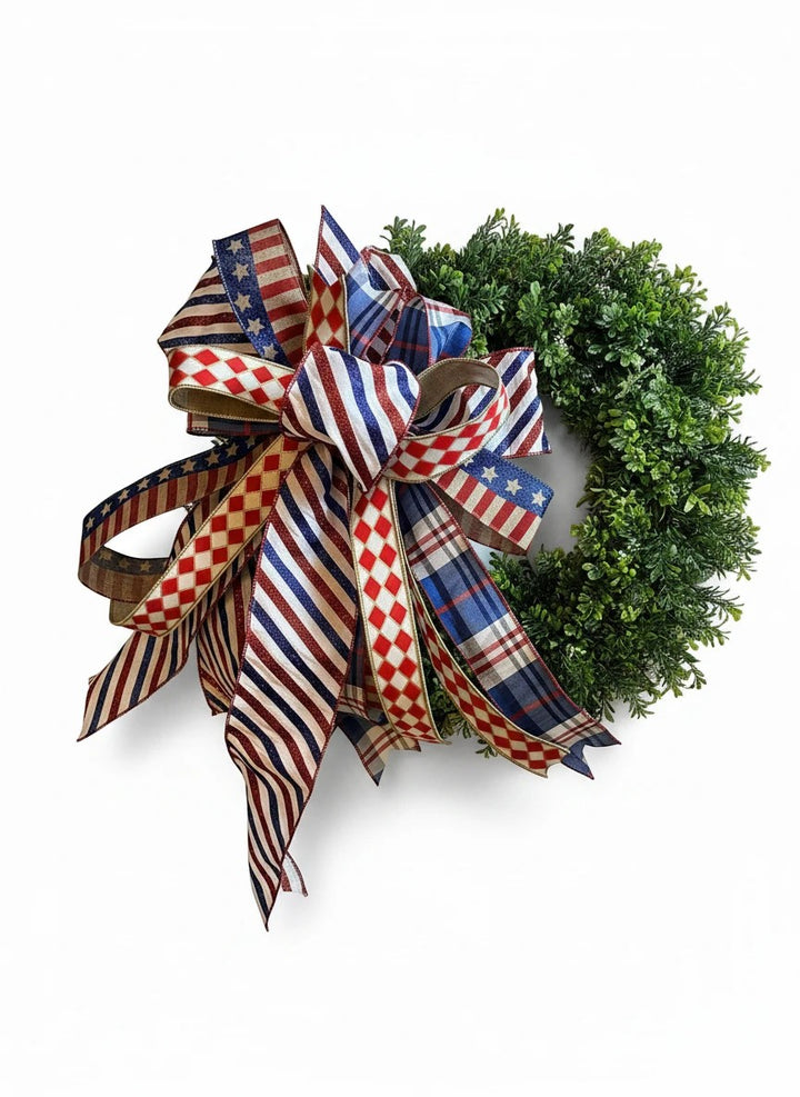 Chic Collective patriotic wreath bow decoration with red, white, and blue ribbon featuring stars, stripes, and plaid patterns.