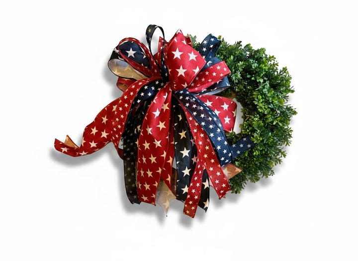 Chic Collective patriotic wreath with red, white, and blue star ribbons and lush green foliage.