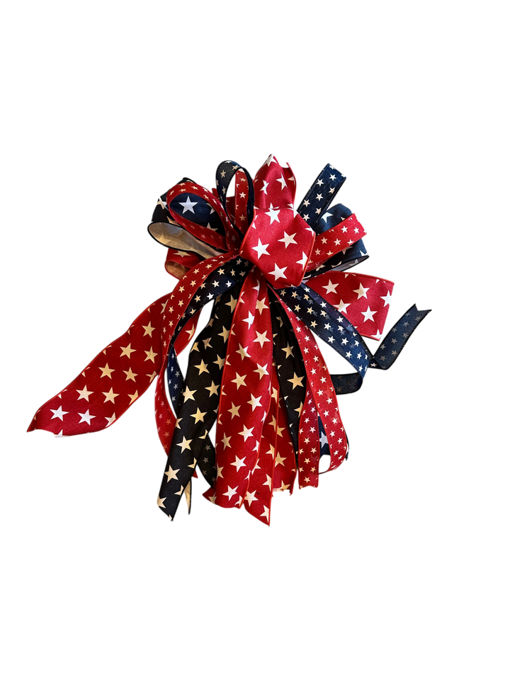 Chic Collective patriotic star ribbon wreath decoration with red, white, and blue ribbons featuring white stars.