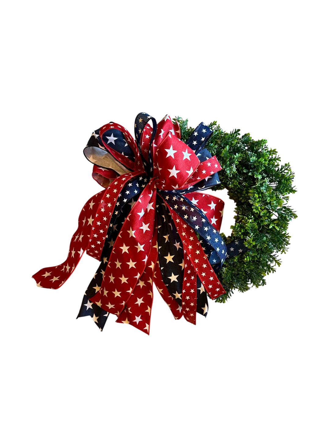 Chic Collective patriotic wreath with red, white, and blue star ribbon bow on a lush green base.