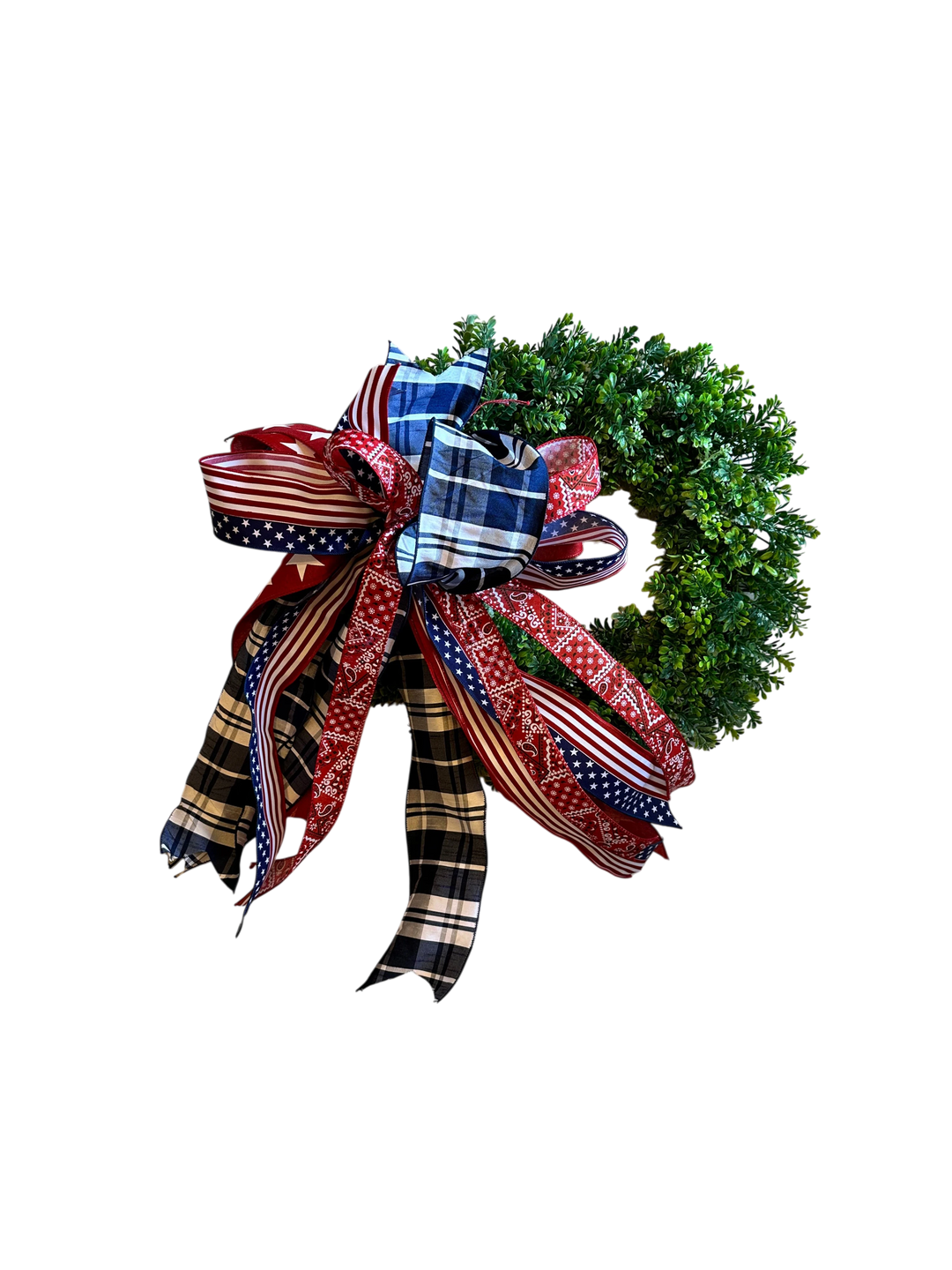 Chic Collective patriotic bow with red, white, and blue star and bandana patterns on a green wreath.