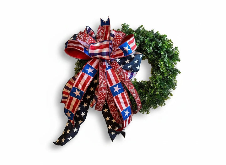 Chic Collective patriotic bow with American flag and bandana print ribbons on a green wreath.
