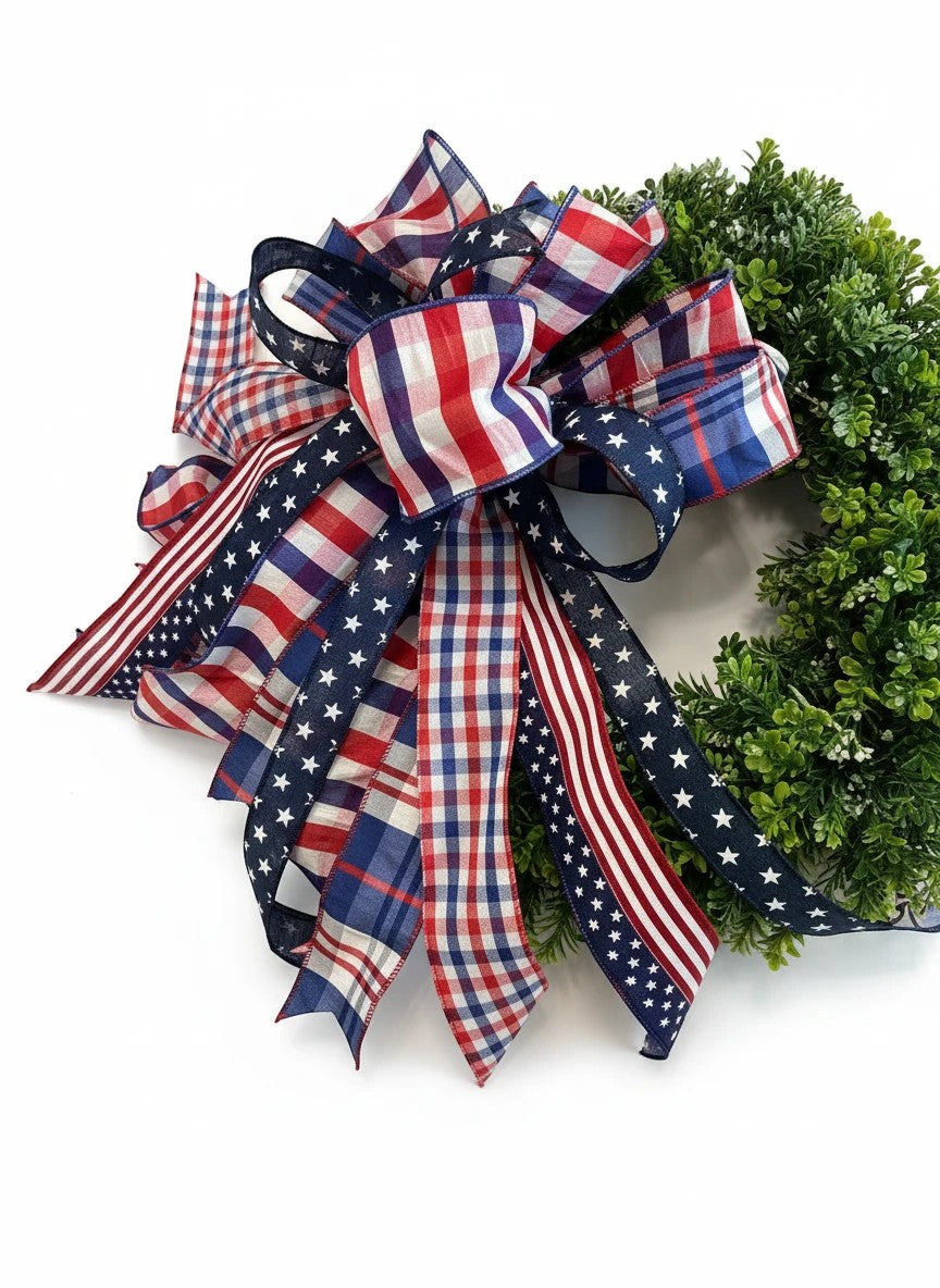 Chic Collective patriotic bow with red, white, and blue plaid and stars ribbons on a green wreath.