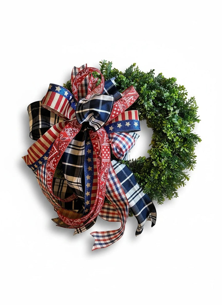 Chic Collective patriotic wreath bow with red, white, and blue plaid and star ribbon accents.