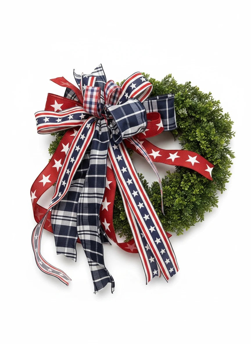 Chic Collective patriotic bow with red, white, and blue plaid and star ribbons on a green wreath.