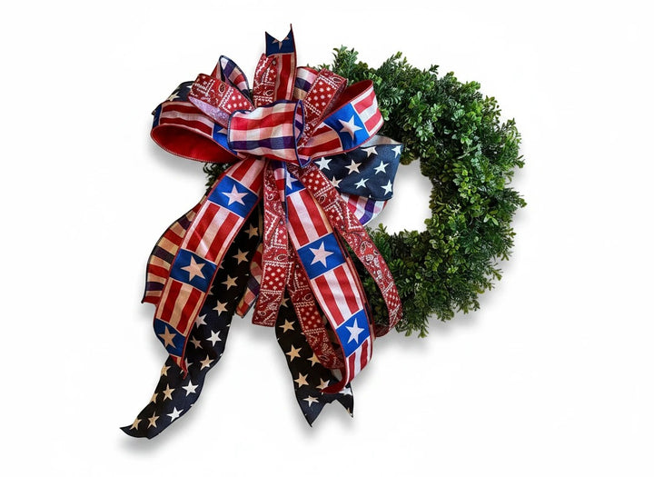 Chic Collective patriotic bow with American flag and bandana print ribbons on a green wreath.