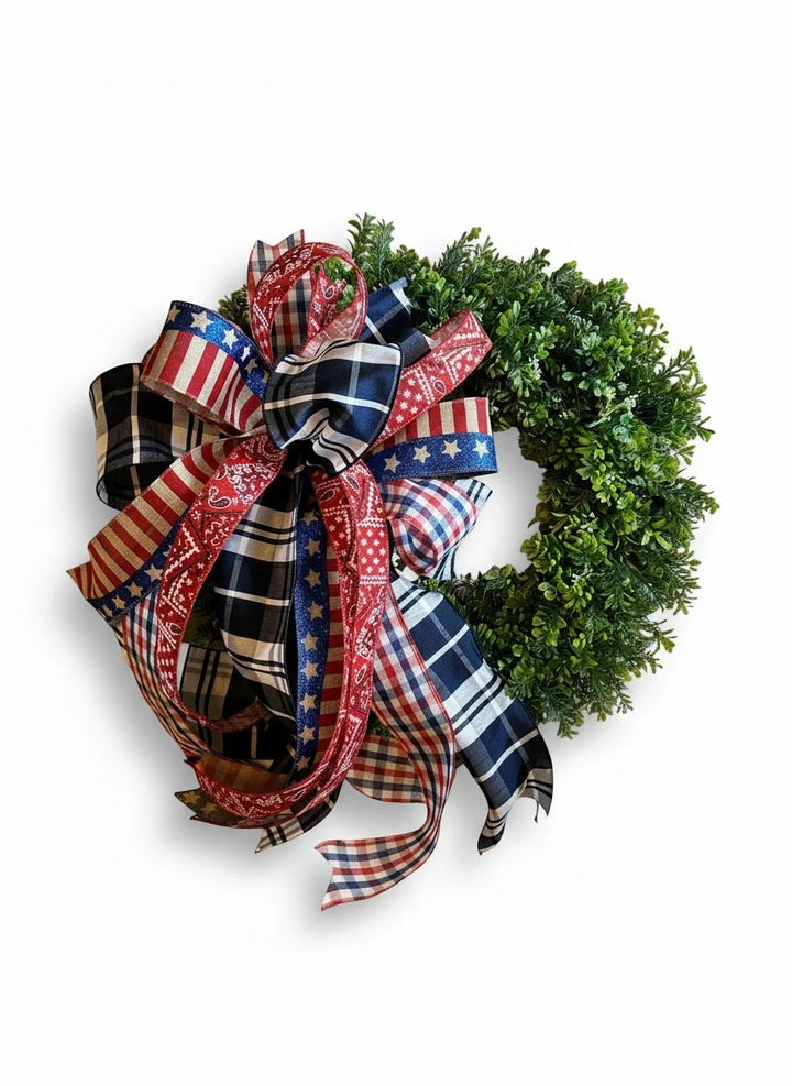 Chic Collective patriotic bow with red, white, and blue plaid, stars, and bandana patterns on a green wreath.