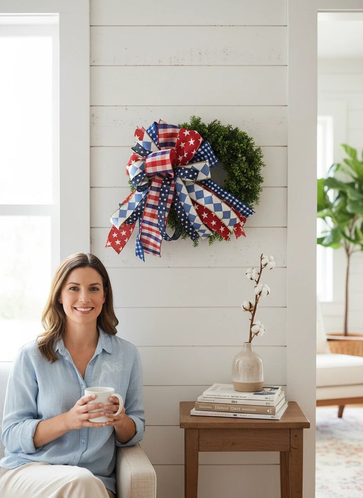 Chic Collective patriotic decorative bow with red, white, and blue stars, gingham, and diamonds on a wreath.