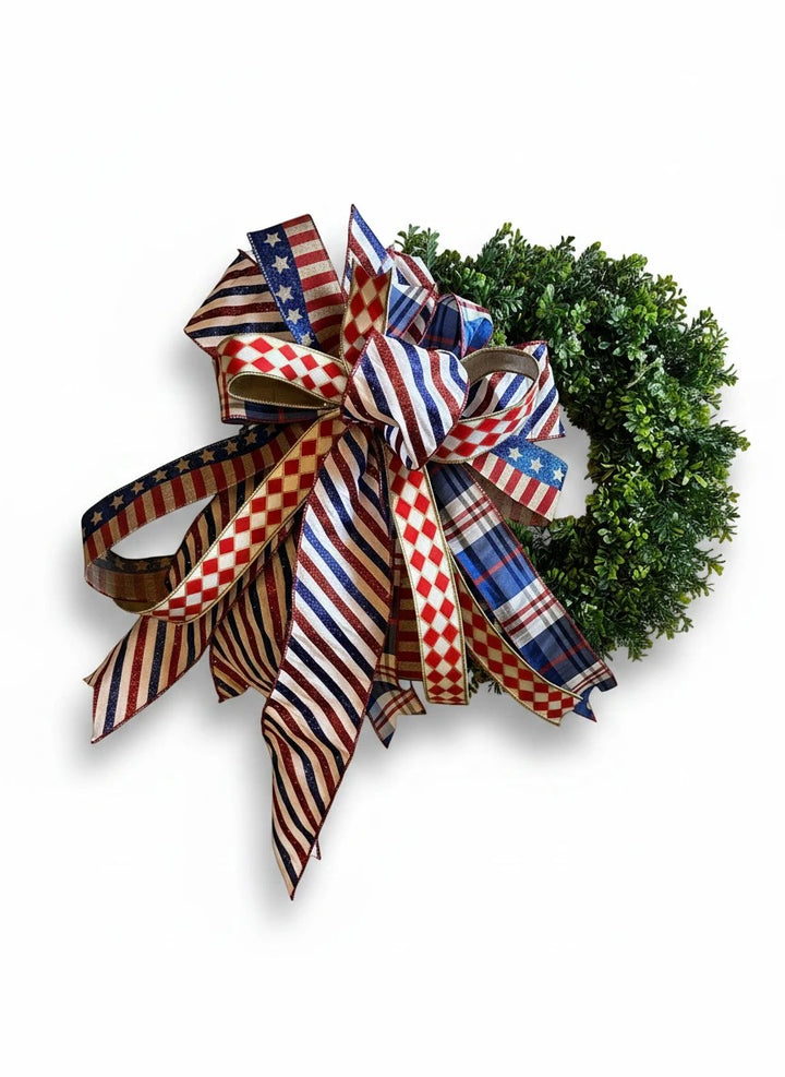 Chic Collective patriotic wreath decoration with red, white, and blue ribbon bow featuring stars, stripes, and plaid patterns.