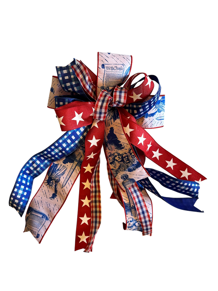 Chic Collective patriotic fabric bow with red, white, and blue gingham, stars, Mount Rushmore, and Constitution text.