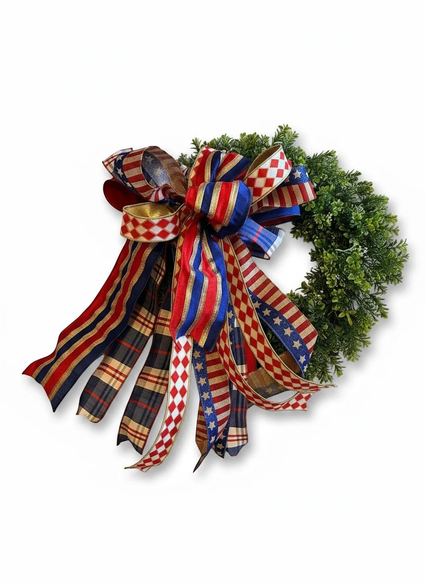 Chic Collective patriotic bow with red, white, blue, and gold ribbons on a green wreath.