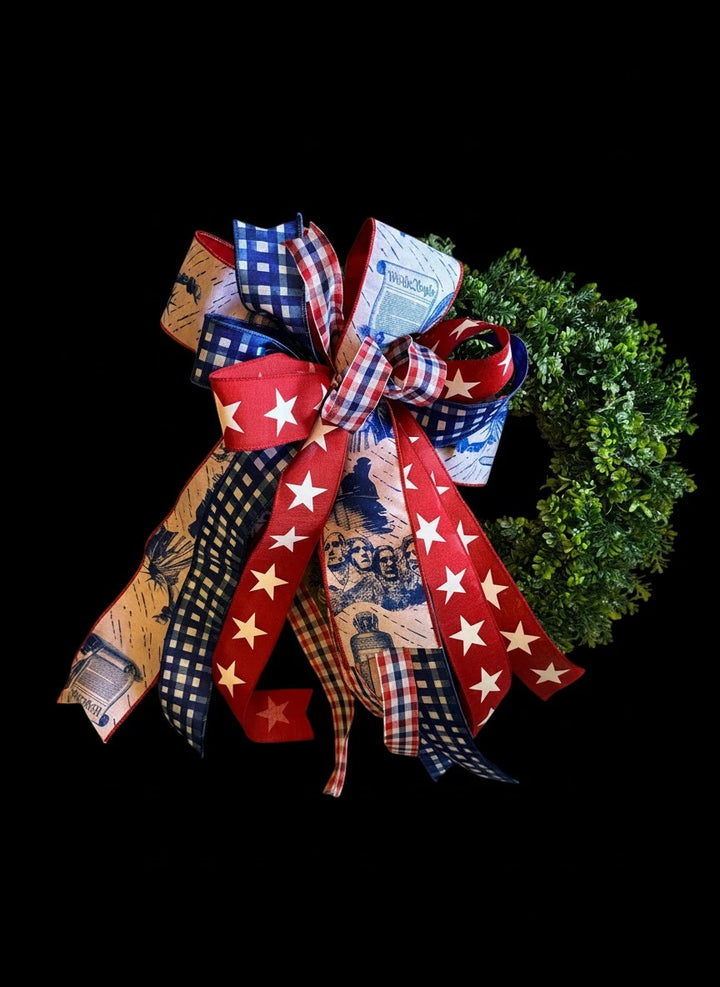 Chic Collective patriotic bow with red, white, and blue ribbons featuring stars, gingham, Mount Rushmore, and "We the People" text.