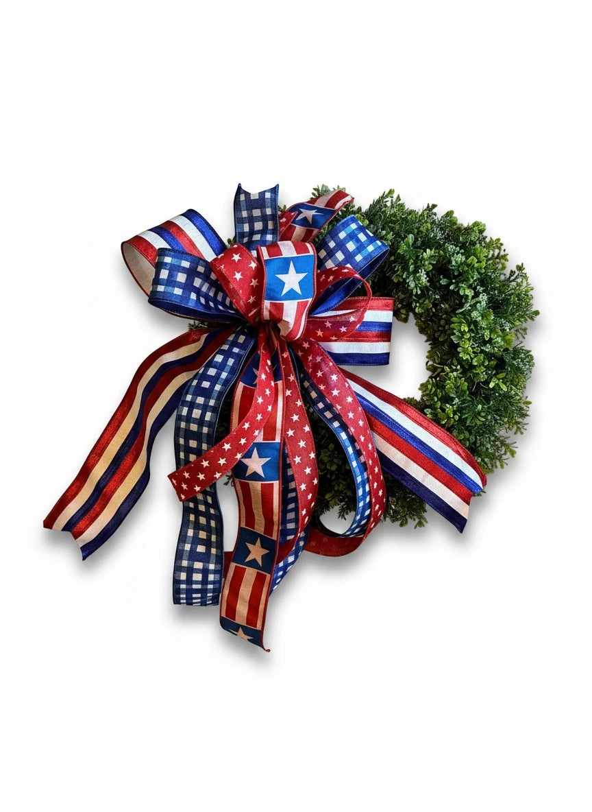 Chic Collective patriotic bow with red, white, and blue ribbons featuring stars and stripes patterns on a small green wreath.