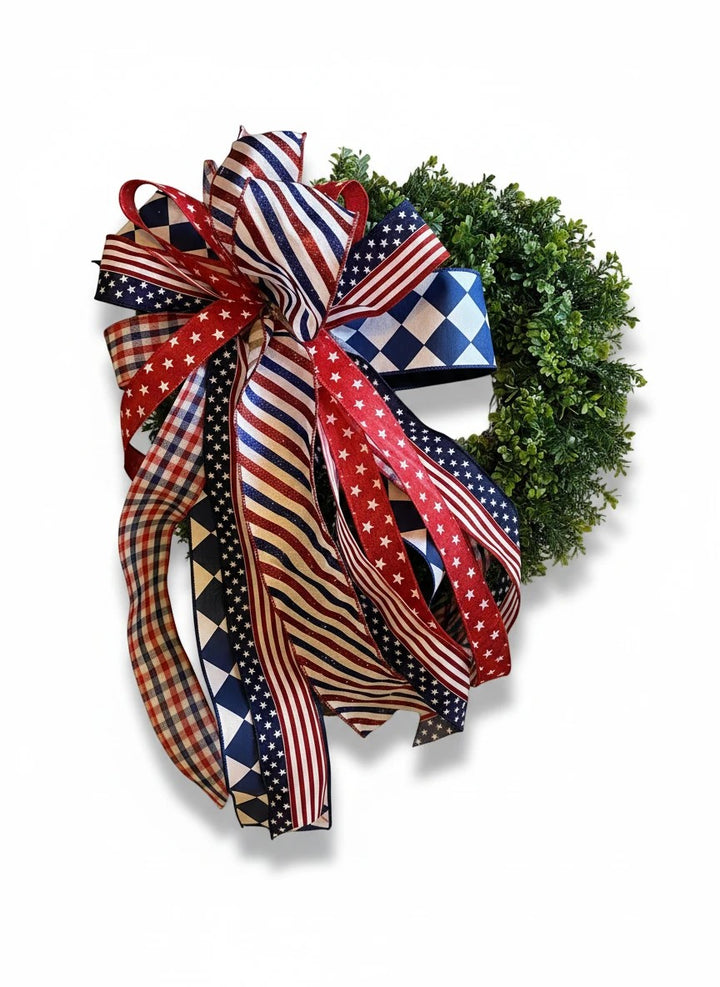Chic Collective patriotic wreath with red, white, and blue ribbon bow featuring stars, stripes, and checkered patterns.