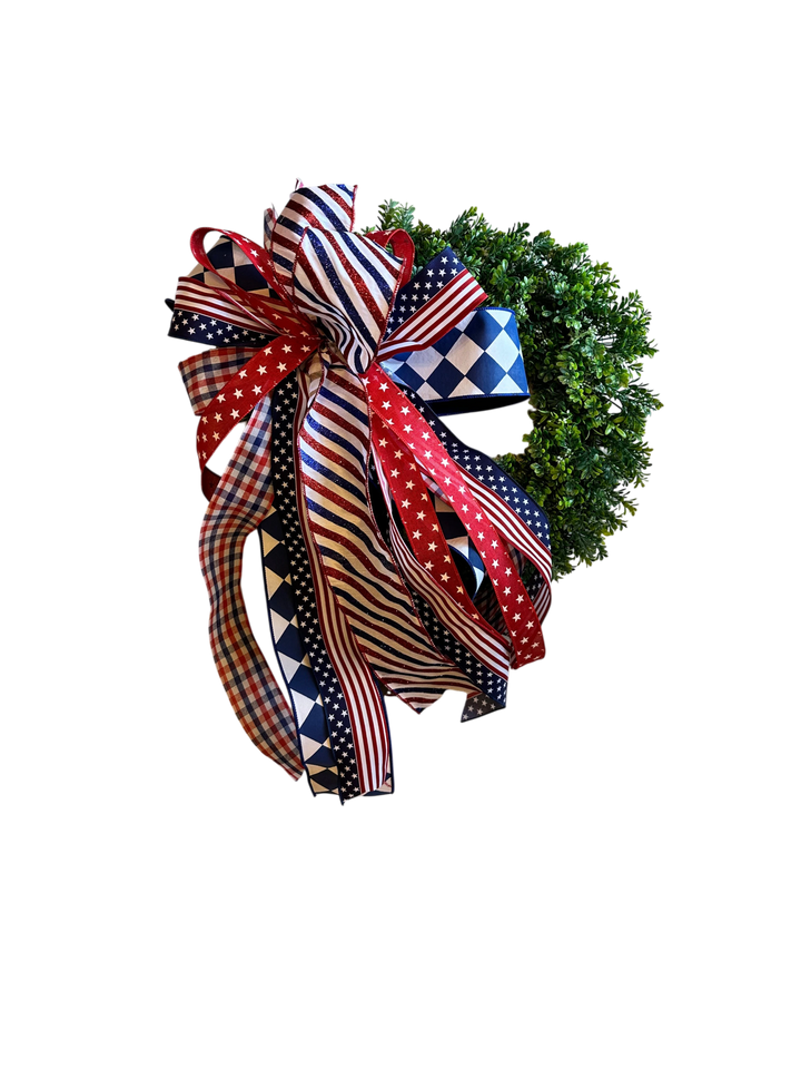 Chic Collective patriotic wreath with red, white, and blue ribbon bow featuring stars, stripes, and checkered patterns.