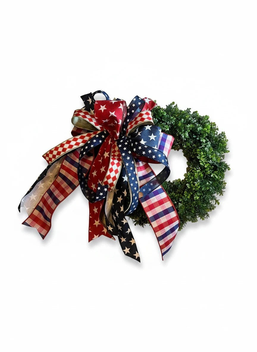Chic Collective patriotic wreath with red, white, and blue star, stripe, and checkered ribbon bow on a lush green base.