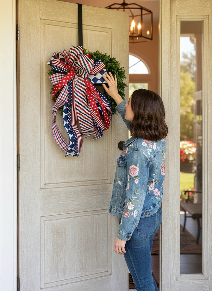 Chic Collective patriotic wreath with red, white, and blue ribbon bow featuring stars, stripes, and checkered patterns.