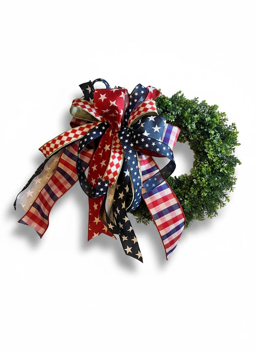 Chic Collective patriotic wreath with red, white, and blue star, stripe, and checkered ribbons. Lush green base.