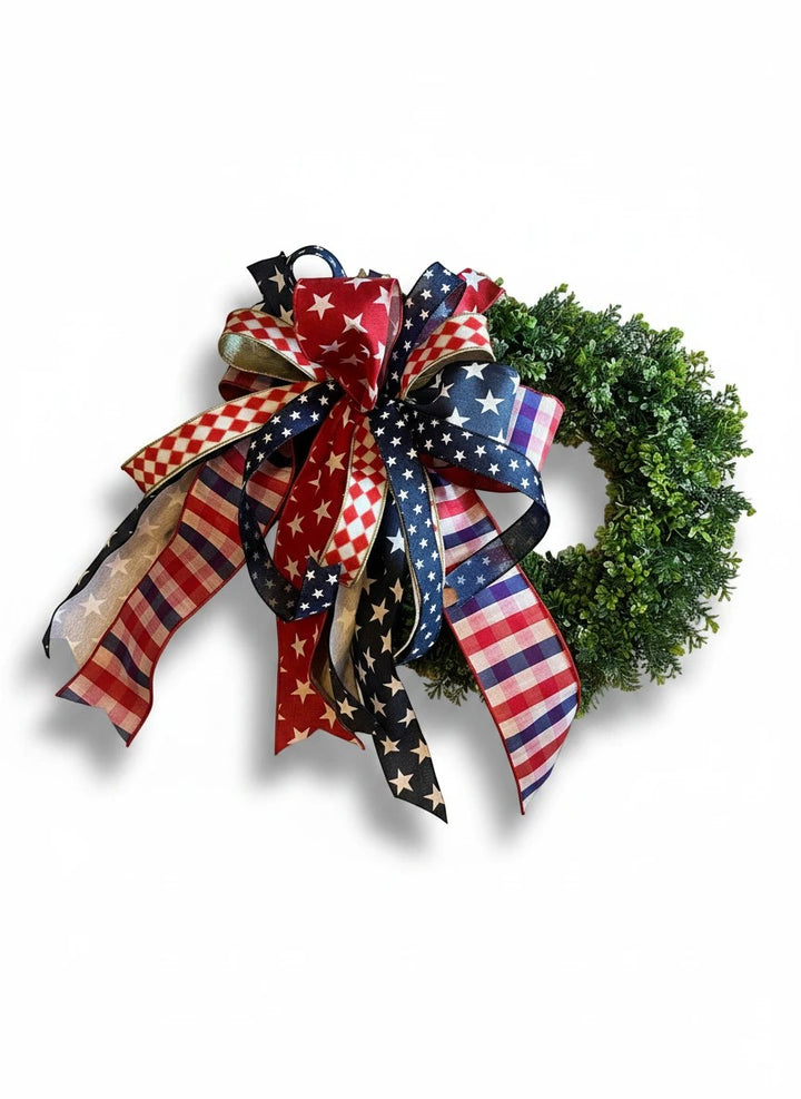 Chic Collective patriotic wreath with red, white, and blue star, stripe, and checkered ribbons. Lush green base.