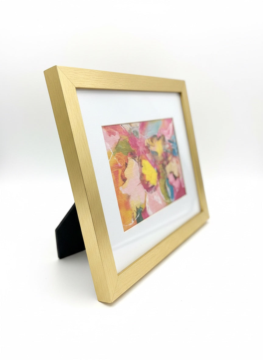 Chic Collective Petals in Motion abstract floral art in a gold frame. Features blush pink, yellow, coral, turquoise, and peach.