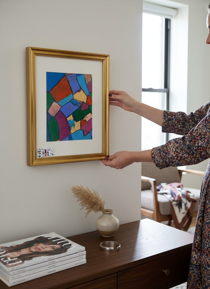 Chic Collective Pieces of Conversation abstract art with jewel tones and gold leaf accents, framed in gold.