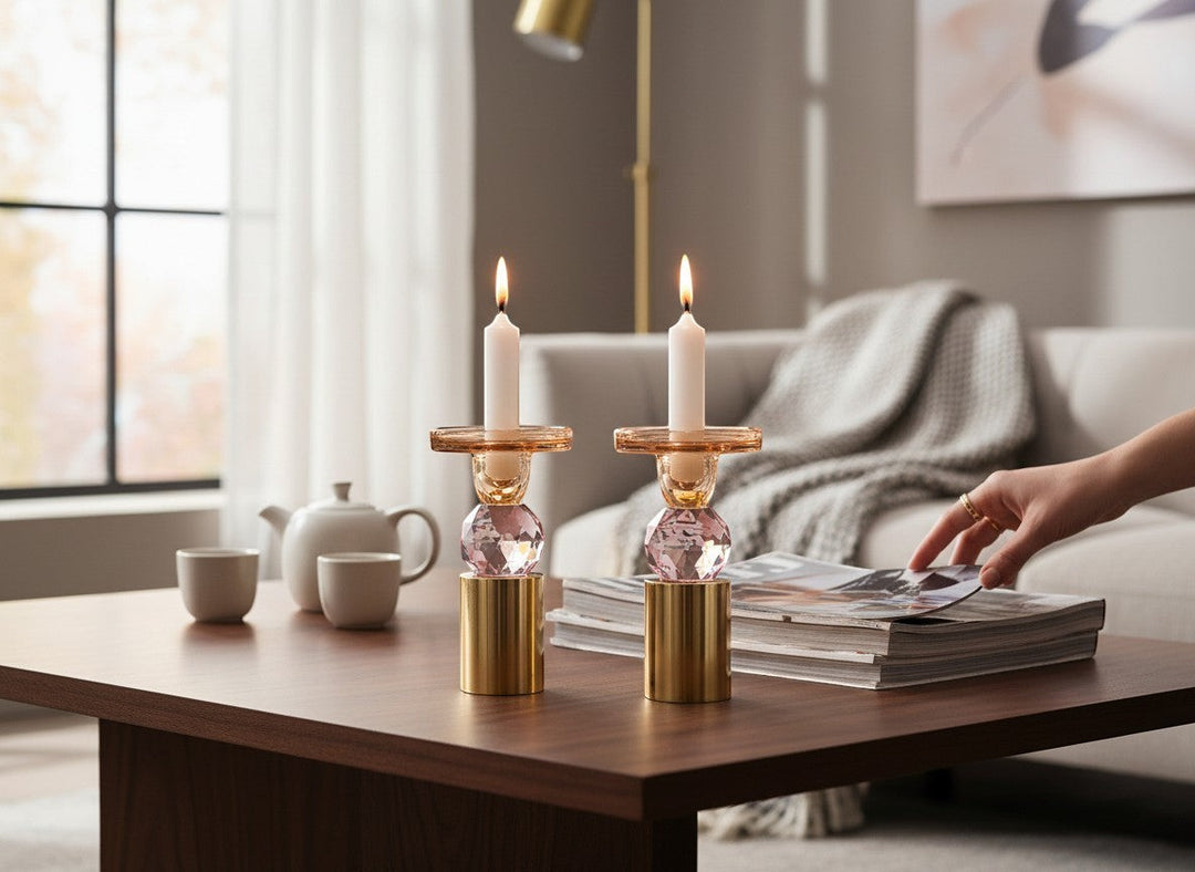 Chic Collective set of 2 pink and amber crystal candlesticks, 6.5"H, with gold base, holding white taper candles.