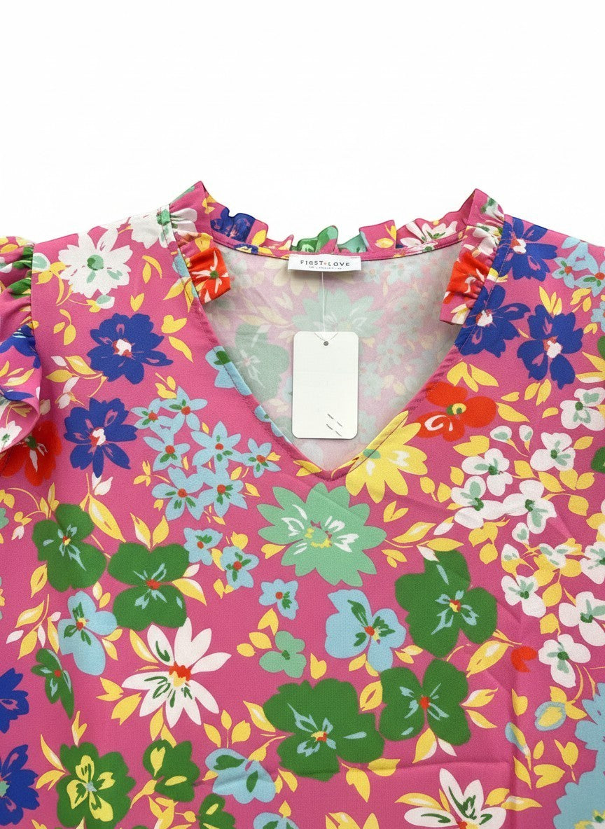 Chic Collective pink floral print blouse with ruffle sleeves, V-neck, and ruffled collar. Features blue, green, white, and yellow flowers.