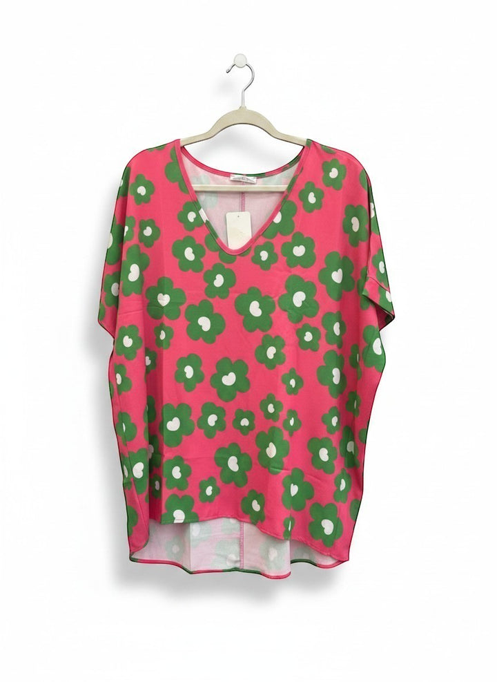Chic Collective pink V-neck top with green and white floral print. Relaxed fit, short sleeves, breathable fabric.