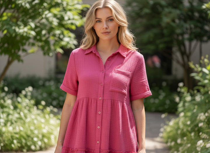 Chic Collective pink gauze tiered mini dress with short sleeves, collared neckline, and button front. Model is wearing size M.