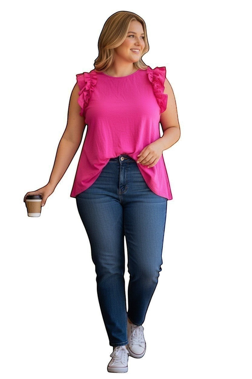 Chic Collective pink knit top with ruffle sleeves, worn by a woman with blue jeans and white sneakers.