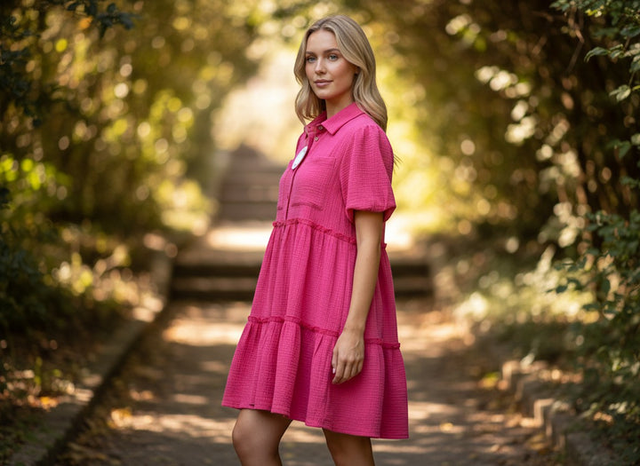 Chic Collective pink mineral wash tiered mini dress with short puff sleeves and collared neckline on a model outdoors.