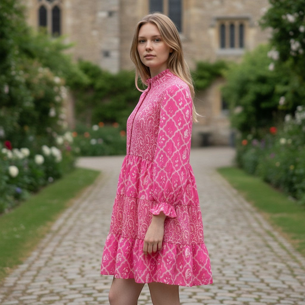 Chic Collective pink and white tiered mini dress with a high neckline and long sleeves, featuring a geometric and paisley print.