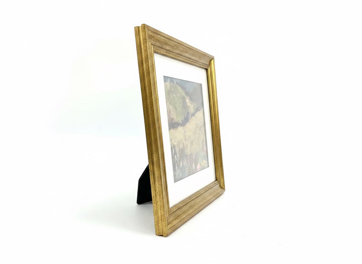 Chic Collective Quiet Meadow framed countryside landscape painting with olive green, taupe, and floral accents in antique gold frame.
