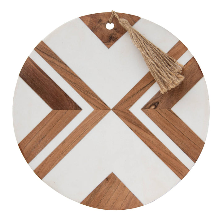 Chic Collective Clement large round cutting board with white resin and wood inlay geometric pattern and jute tassel.