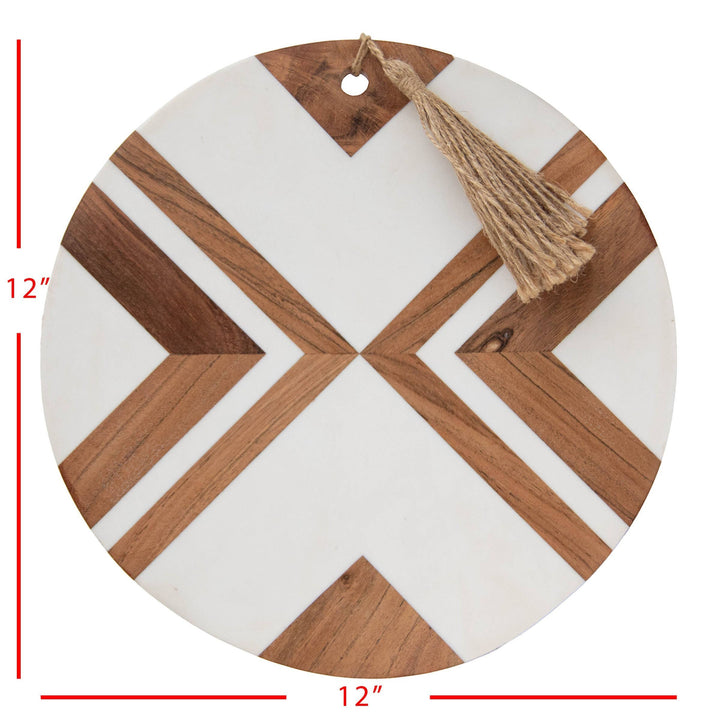 Chic Collective Clement large round cutting board with white resin inlay and acacia wood geometric pattern, featuring a jute tassel.