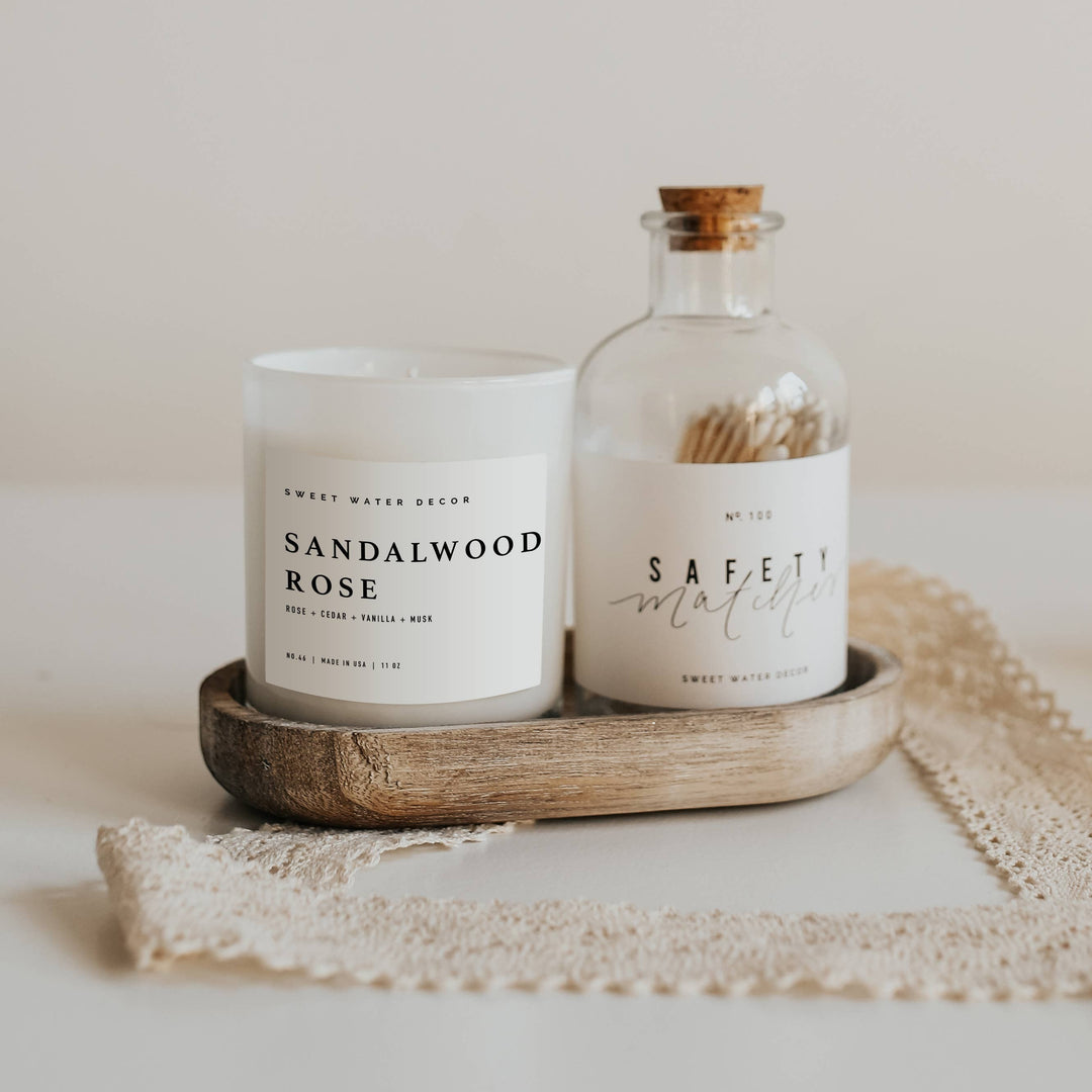 Chic Collective Sandalwood Rose 11 oz soy candle with rose, cedar, vanilla, and musk notes in a white frosted glass jar.