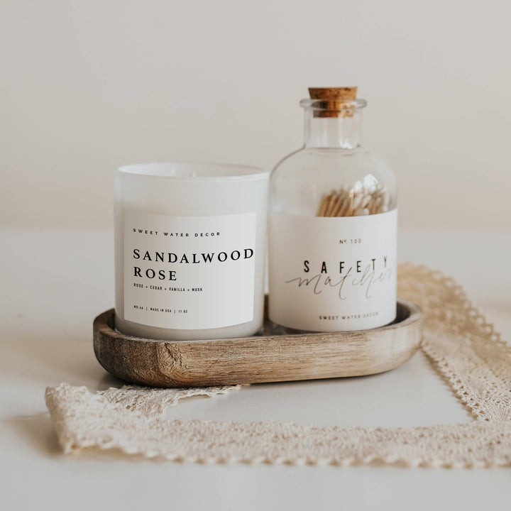 Chic Collective Sandalwood Rose 11 oz soy candle with rose, cedar, vanilla, and musk notes in a white frosted glass jar.
