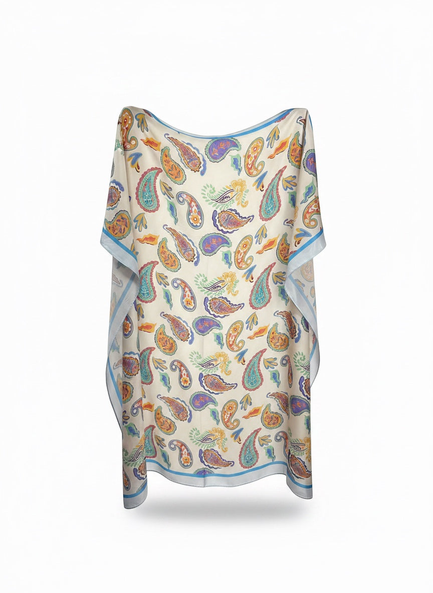 Chic Collective Santorini Paisley Scarf in ivory with turquoise, coral, marigold, periwinkle, and sage paisley print. Features a light blue trim.