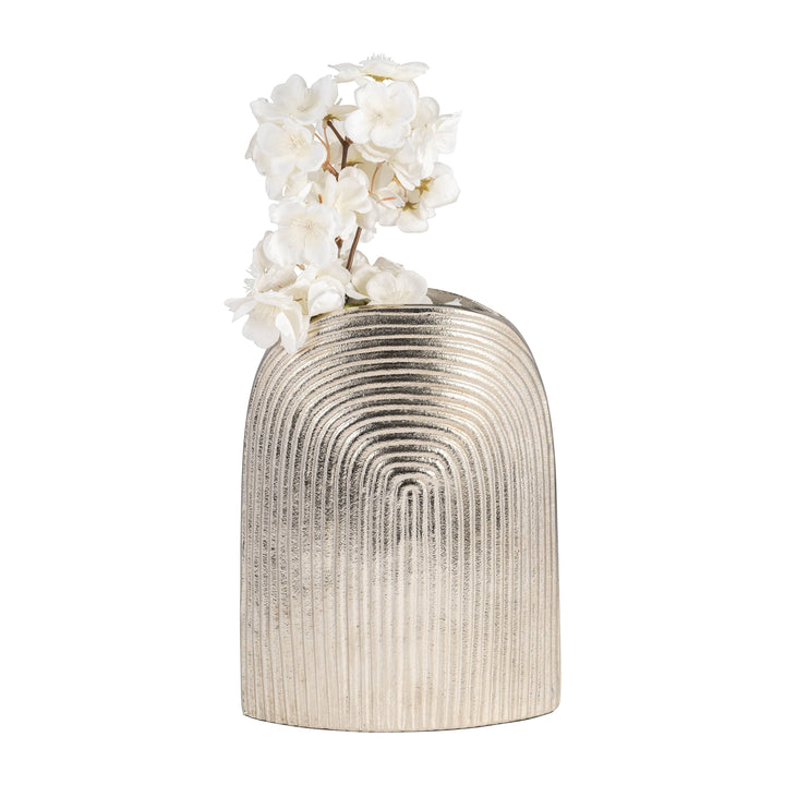 Chic Collective silver aluminum arch vase with striped texture, holding white flowers.