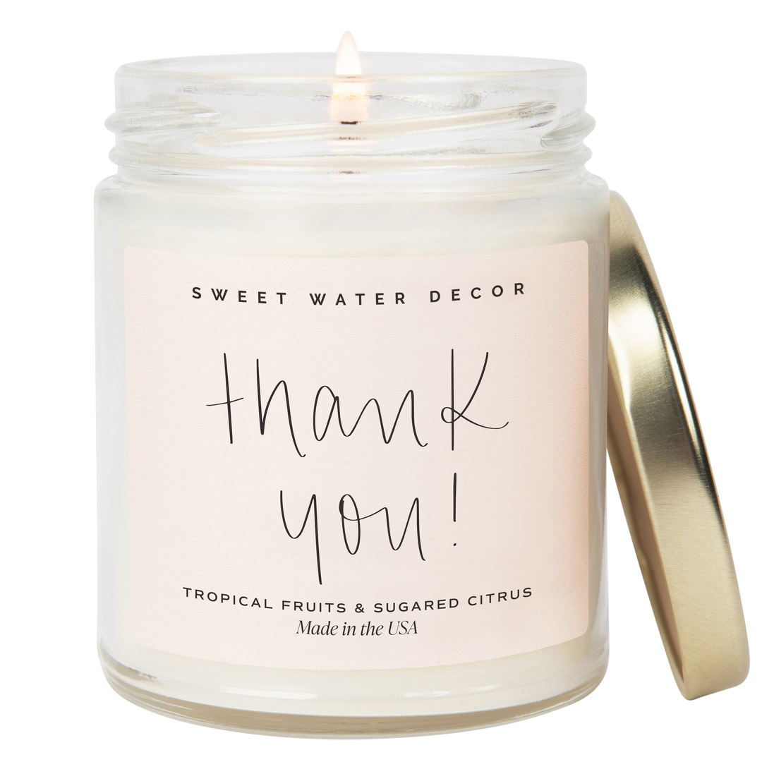 Chic Collective 9 oz soy candle in a clear jar with a gold lid, featuring a pink label with &