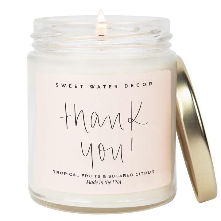 Chic Collective 9 oz soy candle in a clear jar with a gold lid, featuring a pink label with &