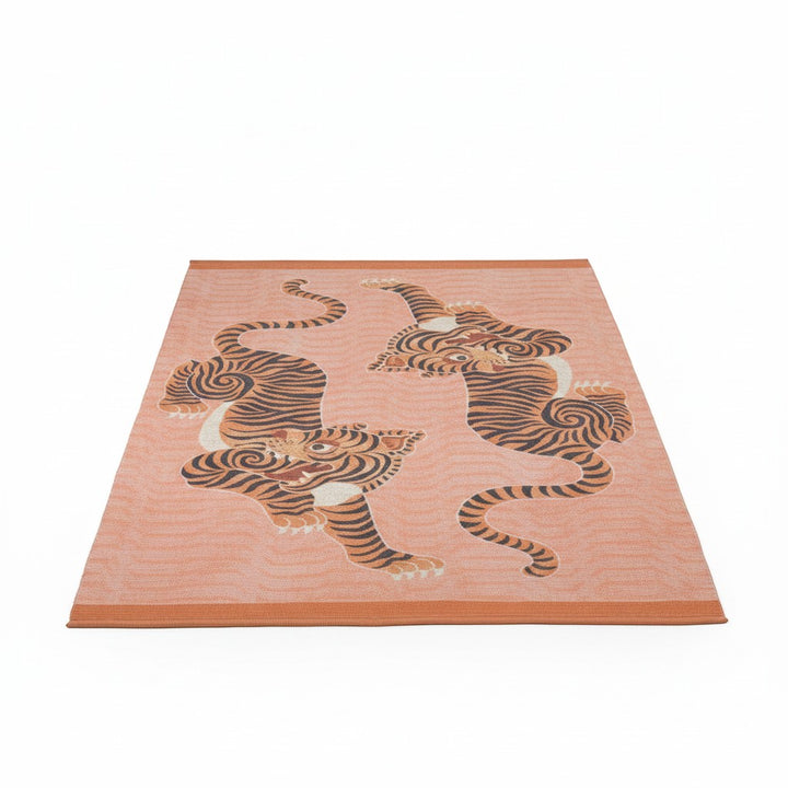 Chic Collective coral orange polyester flatweave rug with two Tibetan tigers design, 120x170cm.