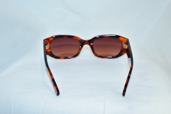 Chic Collective geometric frame sunglasses in tortoise shell pattern with gradient brown lenses and gold accents.